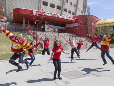 Local actors Mike Roik, left, Gwyn Auger, Sarah Ferguson, Ali Froggatt, Barry Piercey, Aaron Ranger, Brett Hutchinson, and Ellis Lalonde pose in front of the Scotiabank Saddledome in Calgary on Monday, May 4, 2015. The eight actors created a Calgary Flames video about a smartphone app that teaches non-hockey fans hockey lingo.