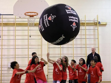 Calgary Flames centre Matt Stajan get the students at Holy Trinity Elementary School active in celebration of Sport Chek's Jumpstart Red Ball month, in Calgary, on May 27, 2015.