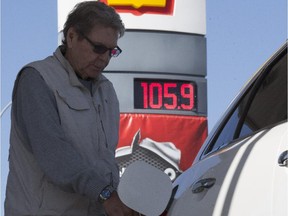 Sam Smith fuels up at a pre-pay only pump after gas prices took a major jump in Calgary, on May 21, 2015.