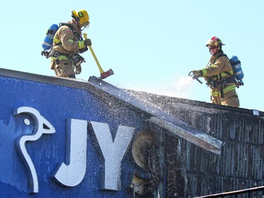 Calgary firefighters search for hot spots after quickly knocking down a two alarm fire behind the JYSK store in Heritage Meadows Wednesday afternoon. It is believed the fire started in an outdoor storage area and is under investigation.