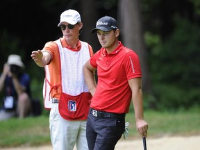 Canadian Adam Svensson and his caddy discuss a shot during final round of the  PC Financial Open at Point Grey Golf Club,  in Vancouver on Sunday. Svensson is part of Golf Canada's Young Pros program.