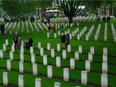 People walk among the graves at the Groesbeek Canadian War Cemetery in the Netherlands. Reader says he is impressed at how faithfully the Dutch tend Canadian soldiers' graves.