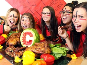 Alissa Kusteriva, Desiree LaRochelle, Emma Paunescu, Julisa Aminzada and Natasha Ivanov, Grade 11 students, support the Calgary Flames by feasting on roast duck at Bishop Grandin High School, cooked by the talented culinary arts students, in Calgary on May 5, 2015.
