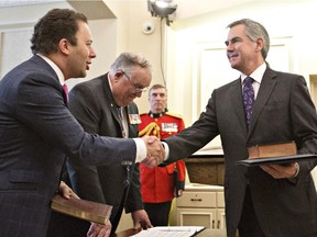 Jonathan Denis ,left, and Alberta's Lieutenant Governor, Donald S. Ethell swear in Jim Prentice as Alberta's 16th Premier in Edmonton, Alberta on Monday September 15, 2014.