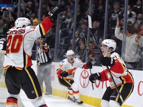 Calgary Flames left wing Johnny Gaudreau, right, celebrates his third goal of the game — a natural hat trick — with Curtis Glencross, left, and Jiri Hudle on Dec. 22 in Los Angeles. The Flames recovered from a 3-0 deficit to win 4-3 in overtime, one of the most memorable moments of the team's magical season.
