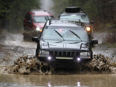Scott Garcia drove his Jeep through the large mud puddles while followed by friends along a trail in the McLean Creek Provincial Recreation area on May 16, 2015.