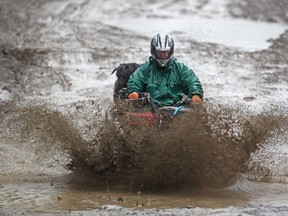 Darren Lane and his dog Dallas hit a mud puddle while quadding at the McLean Creek Provincial Recreation area on May 16, 2015. Lane had been out in the back country visiting his son who was camping.