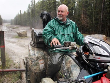 Darren Lane and his dog Dallas made a quick stop after hitting a mud puddle while quadding at the McLean Creek Provincial Recreation area on May 16, 2015. Lane had been out in the back country visiting his son who was camping.