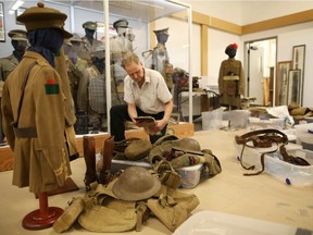 Victor Taboika, looks through one of the many World War 1 items from his private collection that will be in the new temporary display at the Military Museums in Calgary on May 21, 2015.