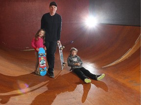 The skateboard family of Wade Cose, with his children Mason, age7, and Madi, 5, show off the ramps in their Lynnview garage Friday May 15, 2015. He moved the mini-halfpipe into his garage about seven years ago after the city forced him to remove the ramp from his backyard.