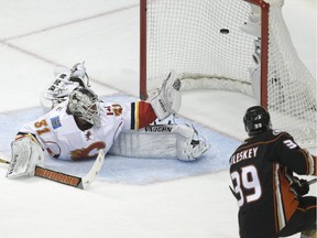 Anaheim Ducks forward Matt Beleskey, right, beats Calgary Flames goalie Karri Ramo for the game winner in the first period.