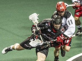 Calgary's Greg Harnett battles Vancouver's Joel McCready during Saturday's game in Langley, B.C. The Roughnecks won 14-13 to make the playoffs.