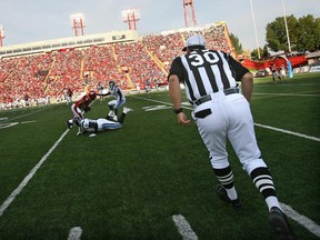 A referee rushes in to make a call during Toronto Argonauts tilt against the Calgary Stampeders.