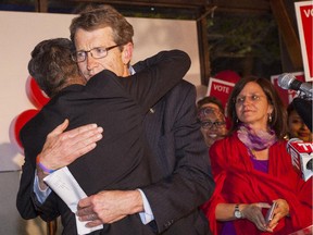 Liberal Leader David Swann hugs David Khan after holding on to his Calgary-Mountain View seat.