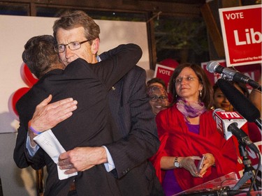David Swann hugs David Khan, MLA, at David Khan's headquarters on Tuesday, May 5, 2015.