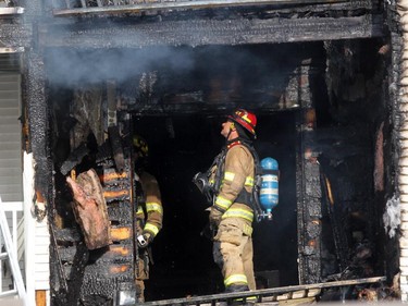 Firefighters check for hot spots after afire at a four-storey condo building in the 2200 block of 1st Street  S.W.