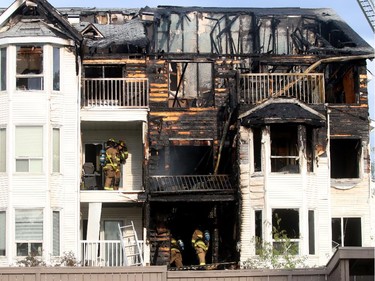 Calgary Fire Fighters checked for hot spots following a 2 alarm fire at a four-storey condo building in the 2200 block of 1st Street  SW  on May 26, 2015. At least four units received extensive damage.