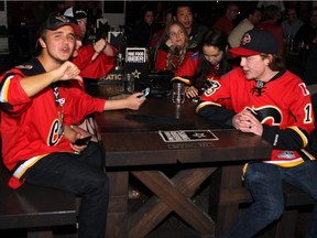 James Callahan, left, with Tristan Gronwald, gives the game the thumbs down at the National on 17th Avenue S.W. after the Flames lost to Anaheim on Sunday, May 10, 2015.
