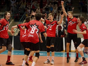Members of the Canuck Dinos celebrate their Canadian U17 boys volleyball championship at the Calgary Corral on Tuesday.