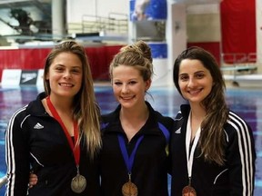 Calgary diver Caeli McKay, centre, is coming off two national championships she wasn't expected to win.