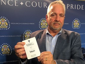 Kevin Brookwell, spokesman for the Calgary Police Service, holds a notebook similar to five others that were stolen from an off-duty officer's vehicle on the evening of April 4.