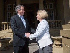 Jim Prentice and premier-designate Rachel Notley shake hands after meeting in Edmonton on Tuesday, May 12, 2015.