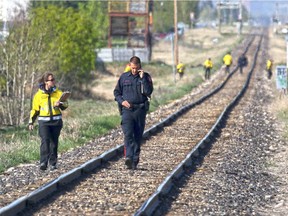 Police and Calgary Search and Rescue search along the CN rail line near Penbrooke Meadows for evidence after a tip in the murder of Maqsood Ahmed led them to the area on Tuesday May 12, 2015.