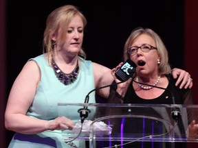 Transport Minister Lisa Raitt prompts Green Party Leader Elizabeth May to stop her speech and leave the stage at the recent  Canadian Parliamentary Press Gallery Dinner.