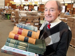 Gerry Morgan, the rare book expert at the Calgary Book Sale, holds five of the unusual titles in this year's offering, on Thursday, April 30, 2015.
