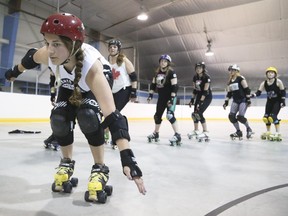 The junior roller derby Team Canada takes turns breaking formation and racing to the inside track line as part of their training at the Acadia Recreation Complex in Calgary on Saturday,