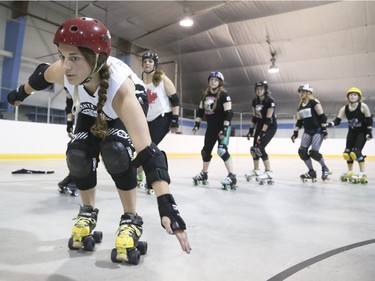 The junior roller derby Team Canada takes turns breaking formation and racing to the inside track line as part of their training at the Acadia Recreation Complex in Calgary on Saturday, May 16, 2015.