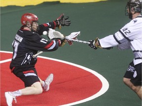 Roughnecks forward Curtis Dickson attempts to block Edmonton Rush  star Mark Matthews from scoring on an empty net at the Scotiabank Saddledome in Calgary on Saturday. The Riggers lost 4-1 in the tiebreaker to be eliminated from the playoffs.