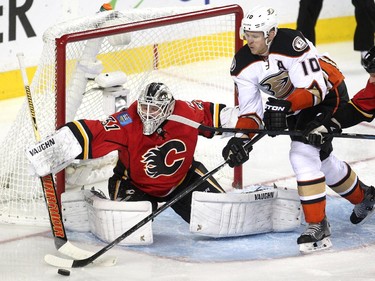 Calgary Flames goalie Karri Ramo reached to deflect the puck as Anaheim Ducks right winger Corey Perry skated with it during third period NHL playoff action at the Scotiabank Saddledome on May 8, 2015. The Ducks won the game 4-2 and took a three games to one lead over the Flames in the series.