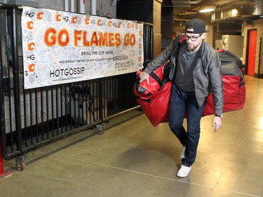 Calgary Flames player goalie Joni Ortio carried his bag out of the building during the annual garbage bag day at the Scotiabank Saddledome on May 12, 2015.