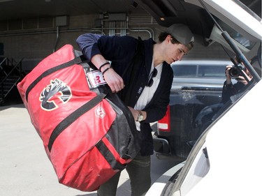 Calgary Flames player centre Joe Colborne put his bag and sticks into the back of his vehicle during the annual garbage bag day at the Scotiabank Saddledome on May 12, 2015.