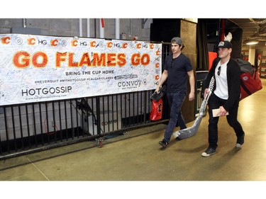 Flames players centre Sean Monahan, left, and centre Lance Bouma walked out after speaking with coaches during the annual garbage bag day at the Scotiabank Saddledome on May 12, 2015.
