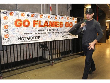 Calgary Flames player defencemand Mark Giordano carried a garbage bag out of the arena during the annual garbage bag day at the Scotiabank Saddledome on May 12, 2015.