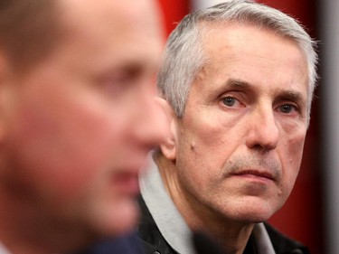 Calgary Flames Head Coach Bob Hartley listened as General Manager Brad Treliving spoke to the media during the annual garbage bag day at the Scotiabank Saddledome on May 12, 2015.