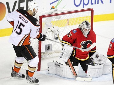 Calgary Flames goalie Karri Ramo kept his eye on the puck as Anaheim Ducks centre Ryan Getzlaf looked for a rebound during first period NHL playoff action at the Scotiabank Saddledome on May 8, 2015.