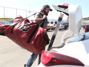 Calgary Flames defenceman David Schlemko loads his equipment bag and sticks into his truck after cleaning out his locker on Tuesday. The rearguard is one of several Flames free agents, who face an uncertain future.