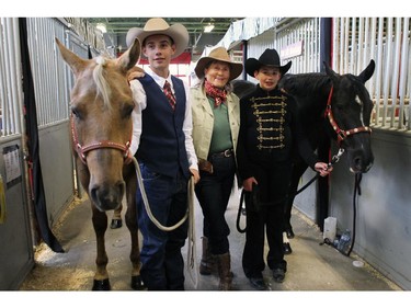 Rancher Lenore McLean, centre with her grandchildren,  Joey, 15, left  with SH Radical Potential; and Ellie, 9, with Peppy's Dandy Bar at the  4-H on Parade competition on May 9, 2015. The grandchildren are 5th generation ranchers that live south of High River.