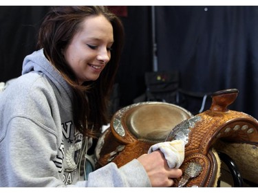 Brandy Lanz polishes the silver on her saddle while taking part in 4-H on Parade on May 29, 2015.