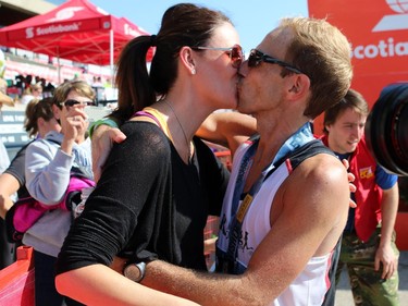 Justin Kurek gets a kiss from his wife Audrey after finishing first in the 50K Ultra marathon.