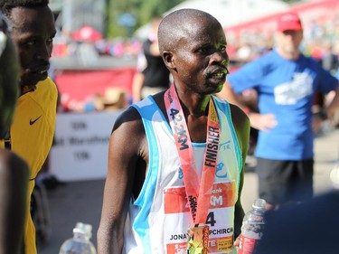 Jonathan Chesoo won the full marathon but had to wait for a ruling on the results as the runner who crossed first was disqualified.