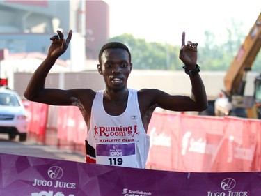 Willy Kimsop crosses the finish line in first place of the 10K race.