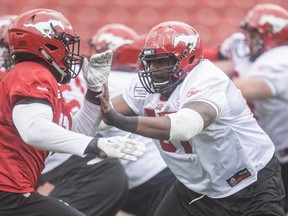 Offensive lineman Garry Williams, right, practises drills on opening day of the Calgary Stampeders rookie camp at McMahon Stadium on Thursday.