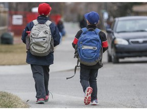 Two boys walk home from school in Calgary.