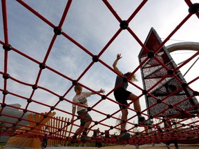 Pete Estabrooks and his son Zyhra,7, go through the science obstacle course called The Brainasium at Telus Spark Science Centre in Calgary on August 14, 2014.