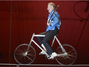 Rick Wallenda rides a bicycle across the high wire at the Royal Canadian Circus at the Crossroads Market in Calgary on Monday, May 11, 2015.