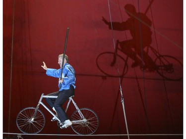 Rick Wallenda rides a bicycle across the high wire act at the Royal Canadian Circus at the Crossroads Market in Calgary on Monday, May 11, 2015.